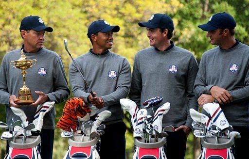 American Team member Tiger Woods (2nd L) talks with Davis Love III (L), Keegan Bradley (2nd R) and Dustin Johnson